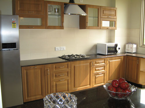 modular Kitchen with Vitrified tile and wooden flooring